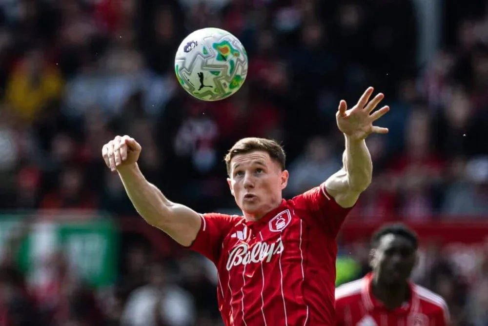 Elliot Anderson leaps to head the ball away